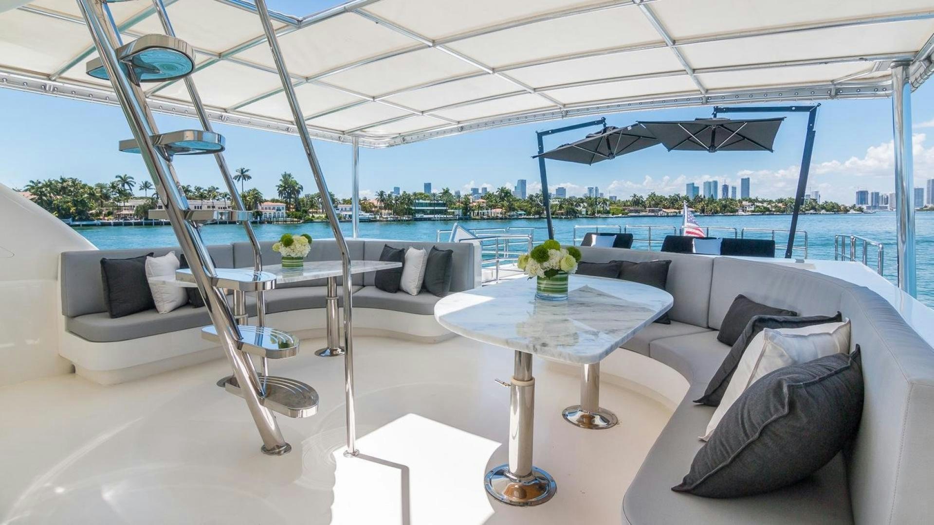 a room with a couch and a table and a large window aboard NIRVANA Yacht for Sale