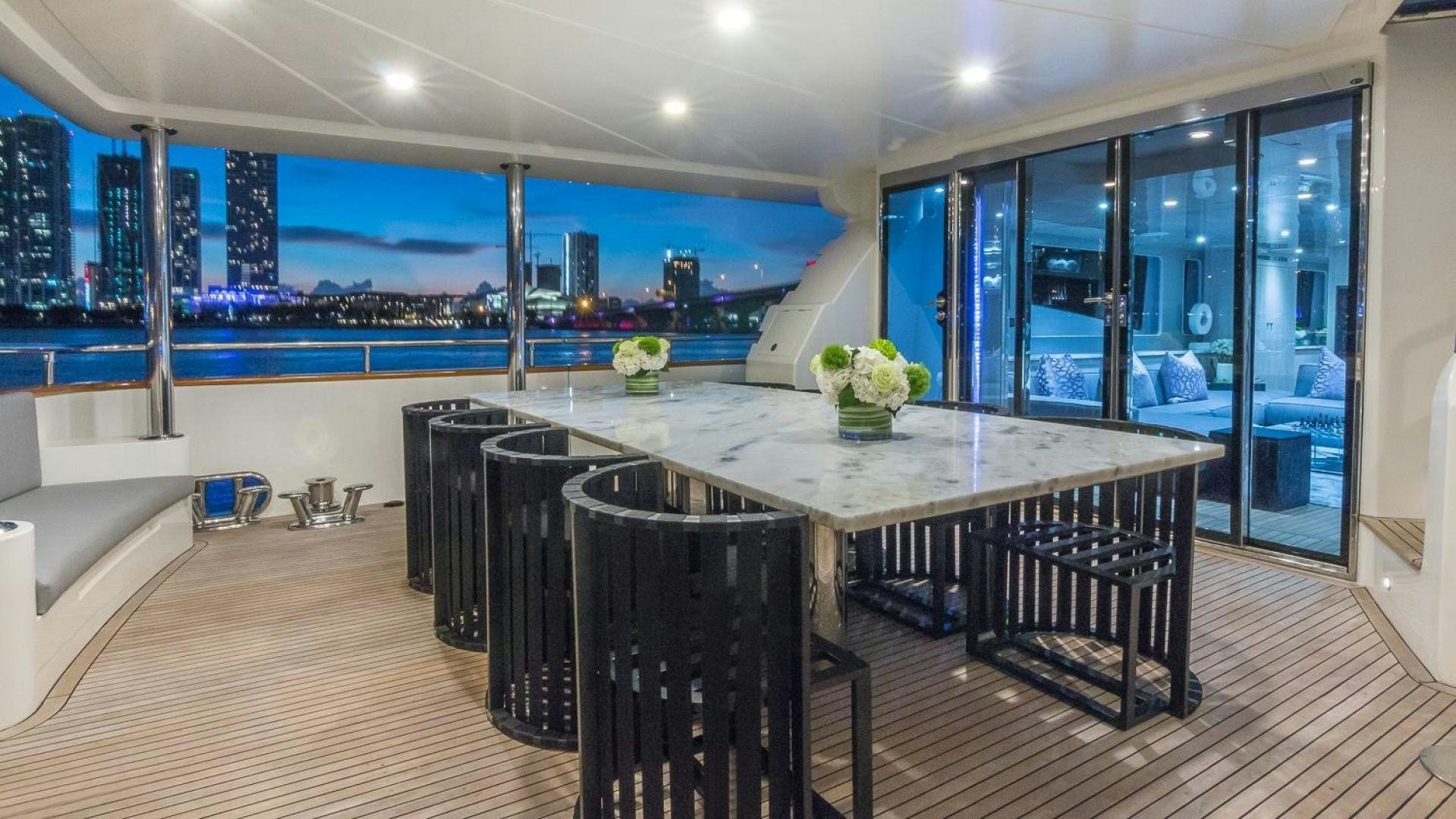 a large room with a table and chairs aboard NIRVANA Yacht for Sale