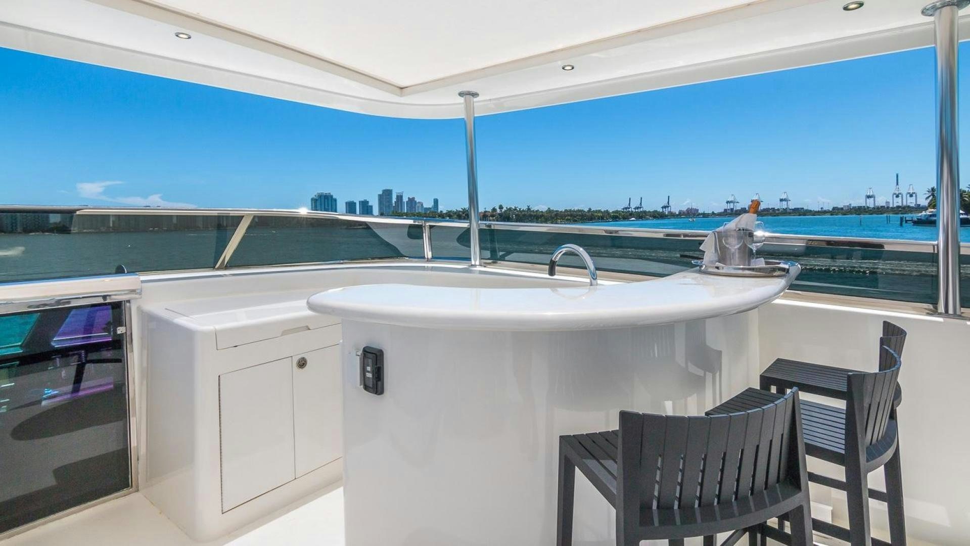 a white table and chairs on a balcony overlooking a body of water aboard NIRVANA Yacht for Sale