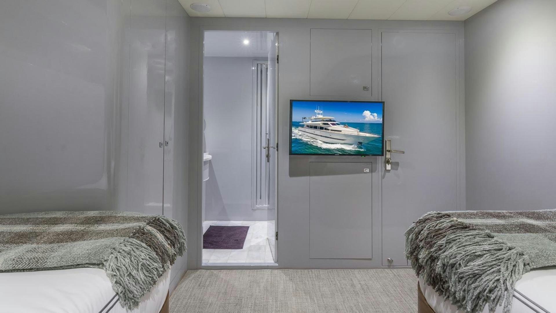 a tv on a stand in a room aboard NIRVANA Yacht for Sale