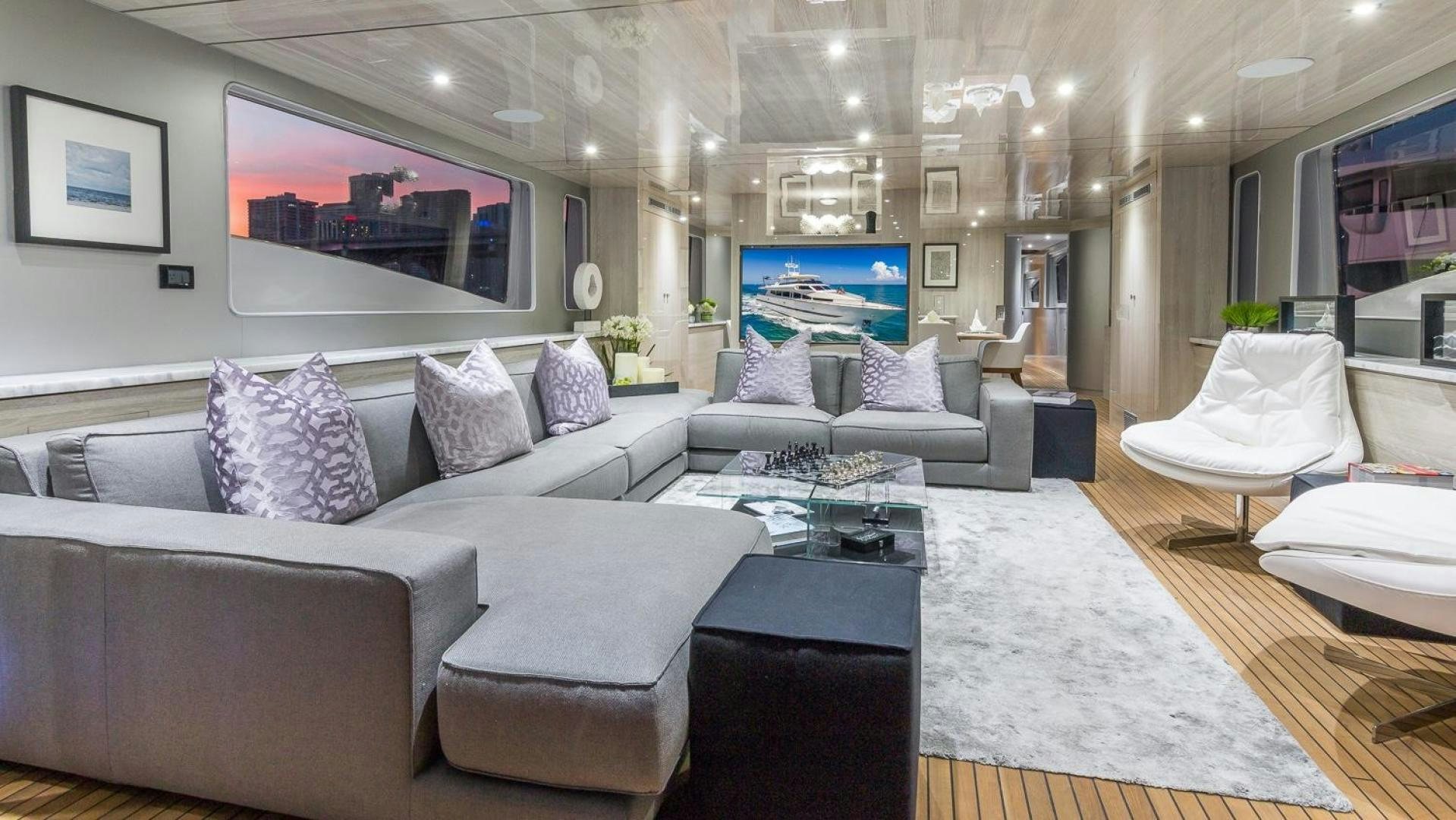 a living room with white furniture aboard NIRVANA Yacht for Sale