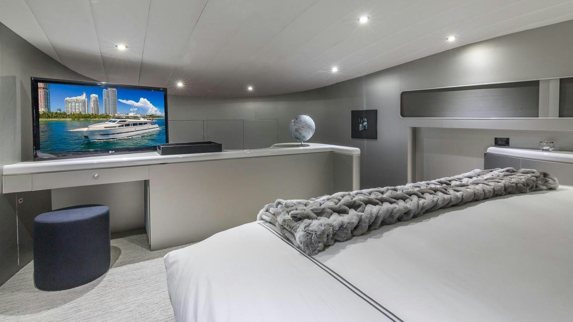 a room with a bed and a tv on the wall aboard NIRVANA Yacht for Sale