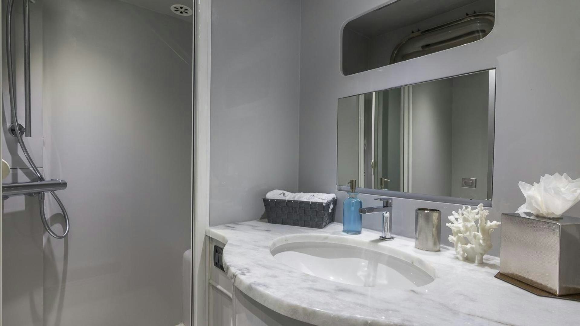 a bathroom with a sink and mirror aboard NIRVANA Yacht for Sale