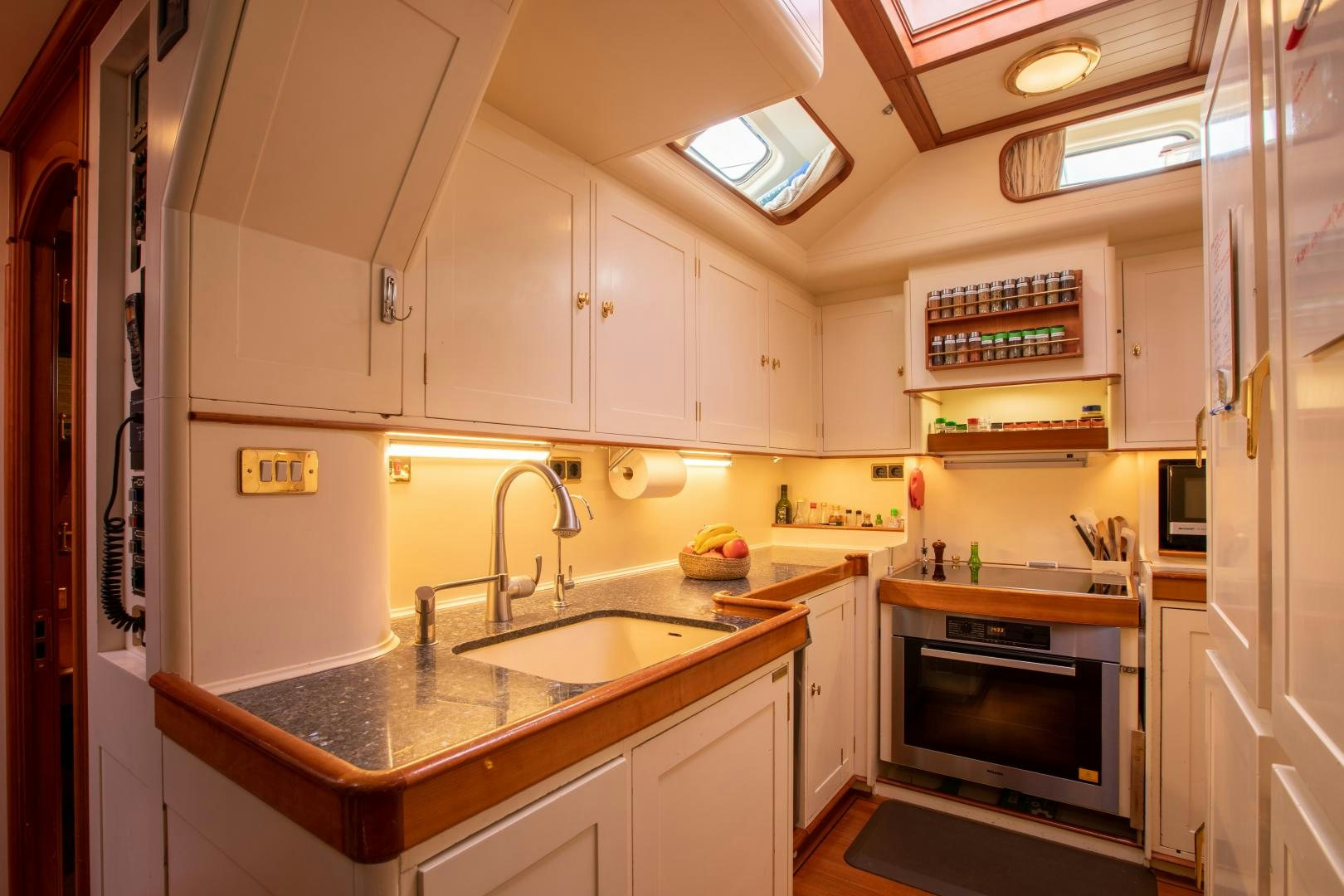 a kitchen with white cabinets aboard AUDREY II Yacht for Sale