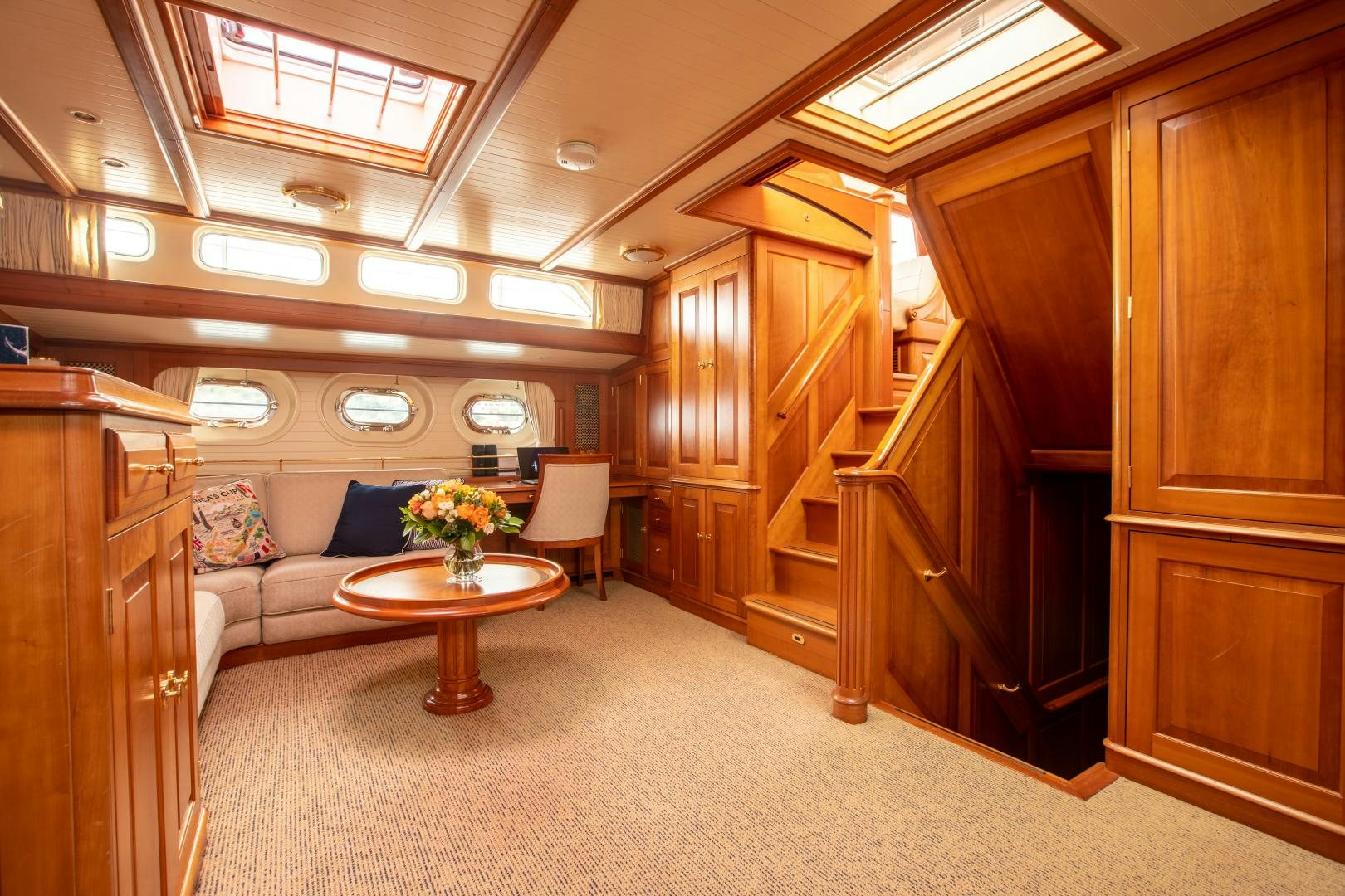 a living room with a couch and a table aboard AUDREY II Yacht for Sale