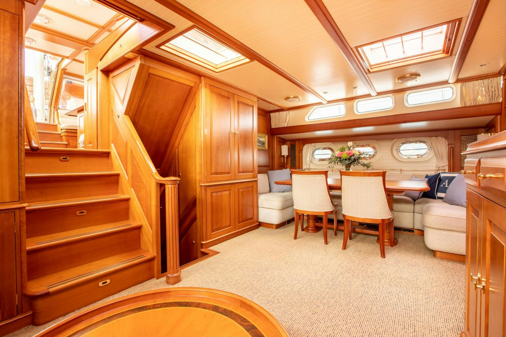a room with a bed and a table and chairs aboard AUDREY II Yacht for Sale