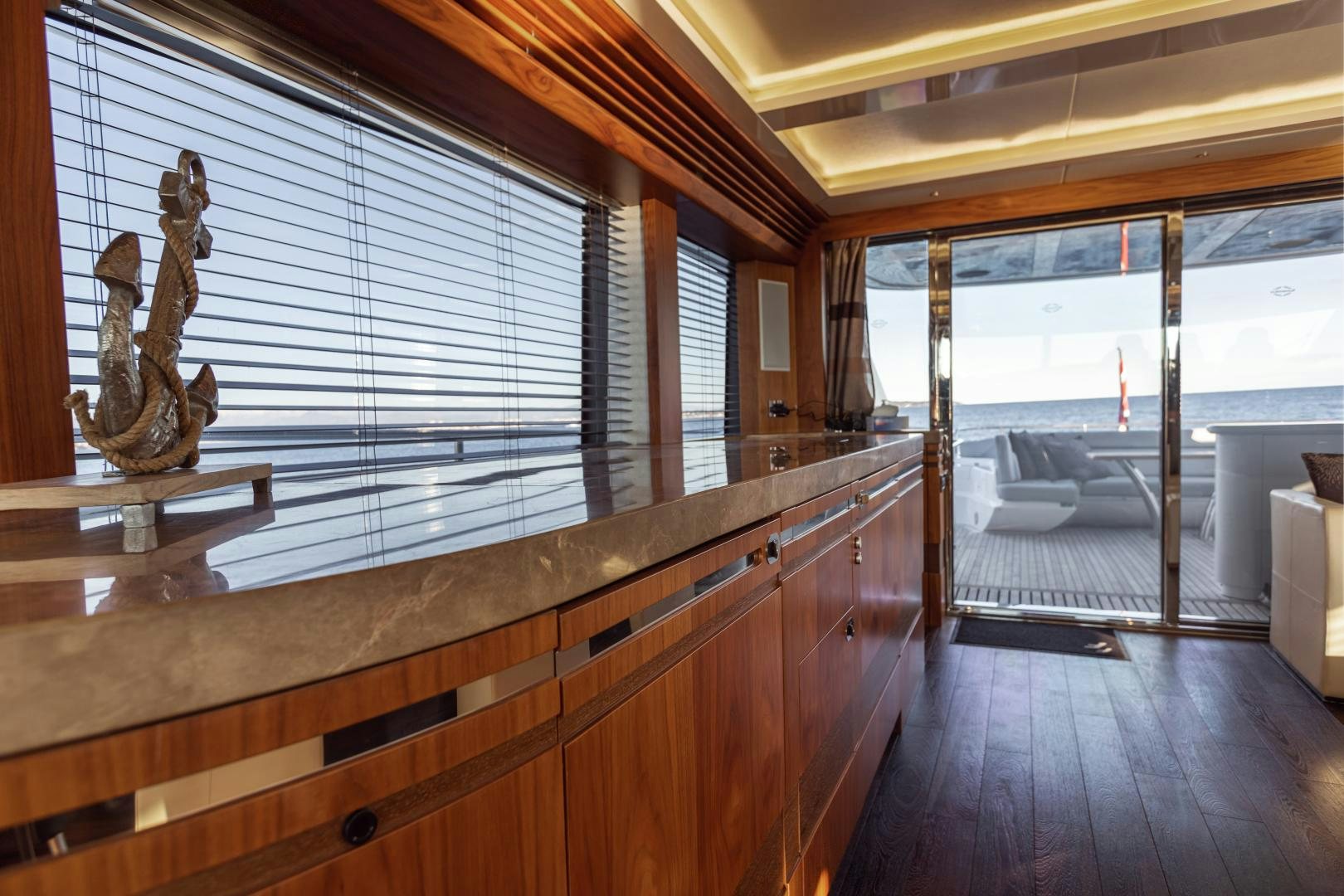 a large wooden room with a wood bench and a large statue aboard FREAKY FRANKS Yacht for Sale