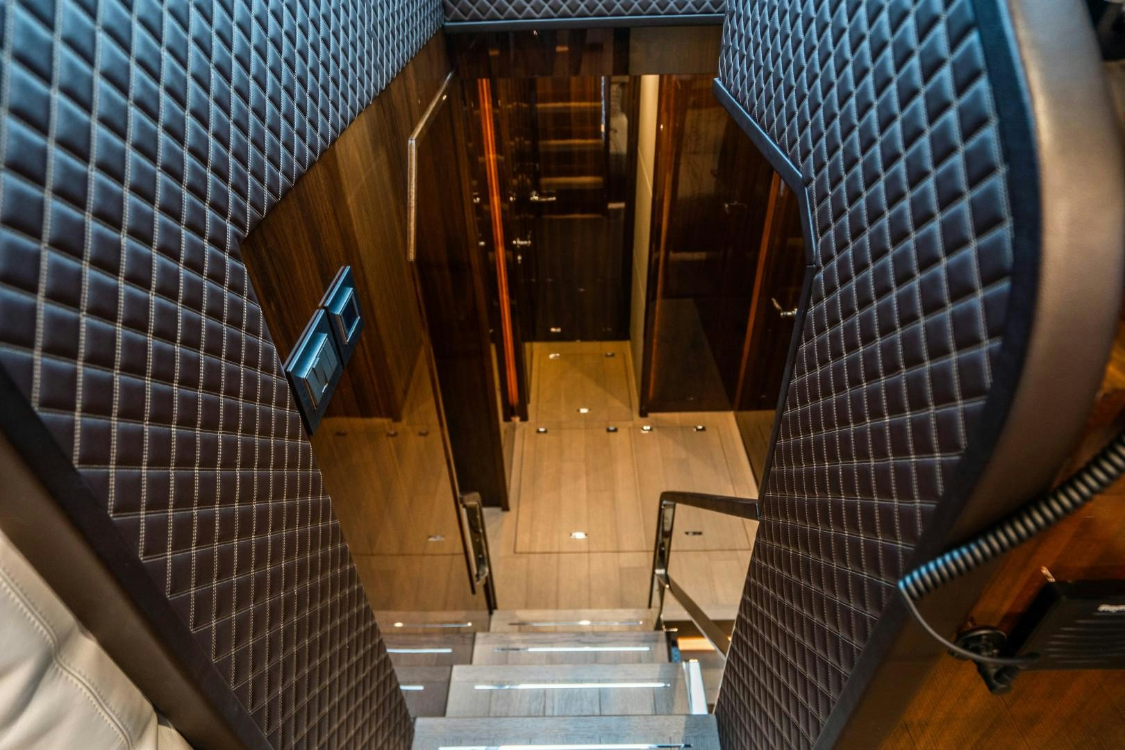 a tiled staircase with glass walls aboard BLIND DATE Yacht for Sale