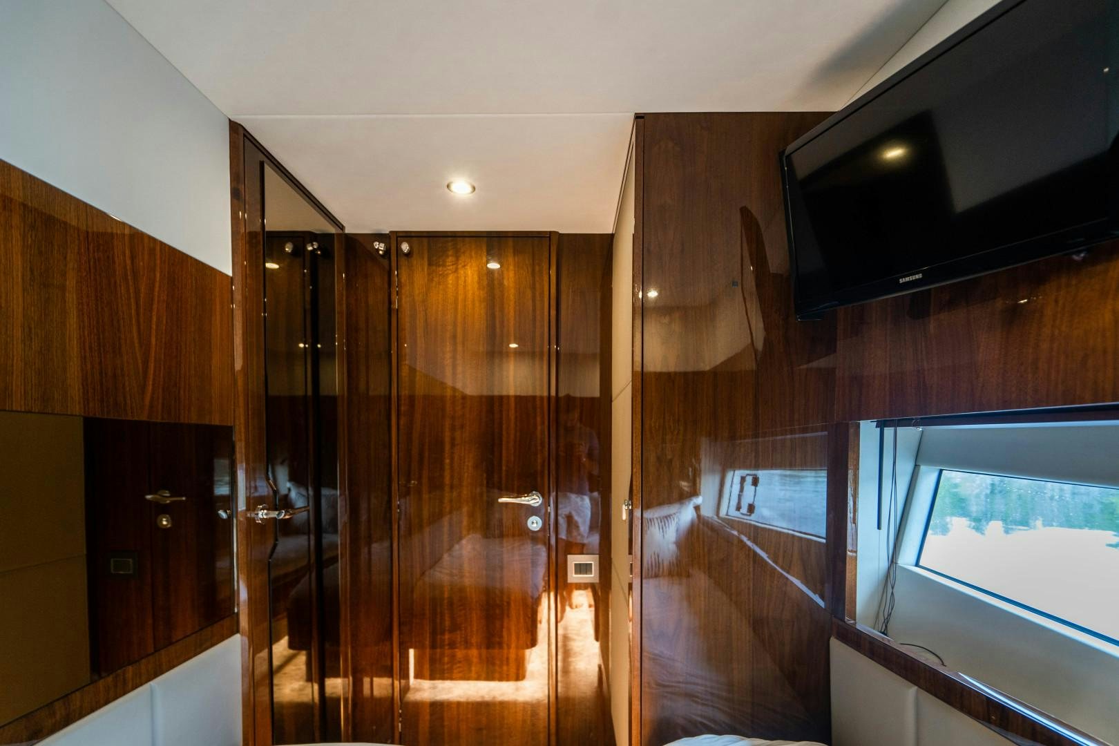a room with a wood floor and a tv on the wall aboard BLIND DATE Yacht for Sale