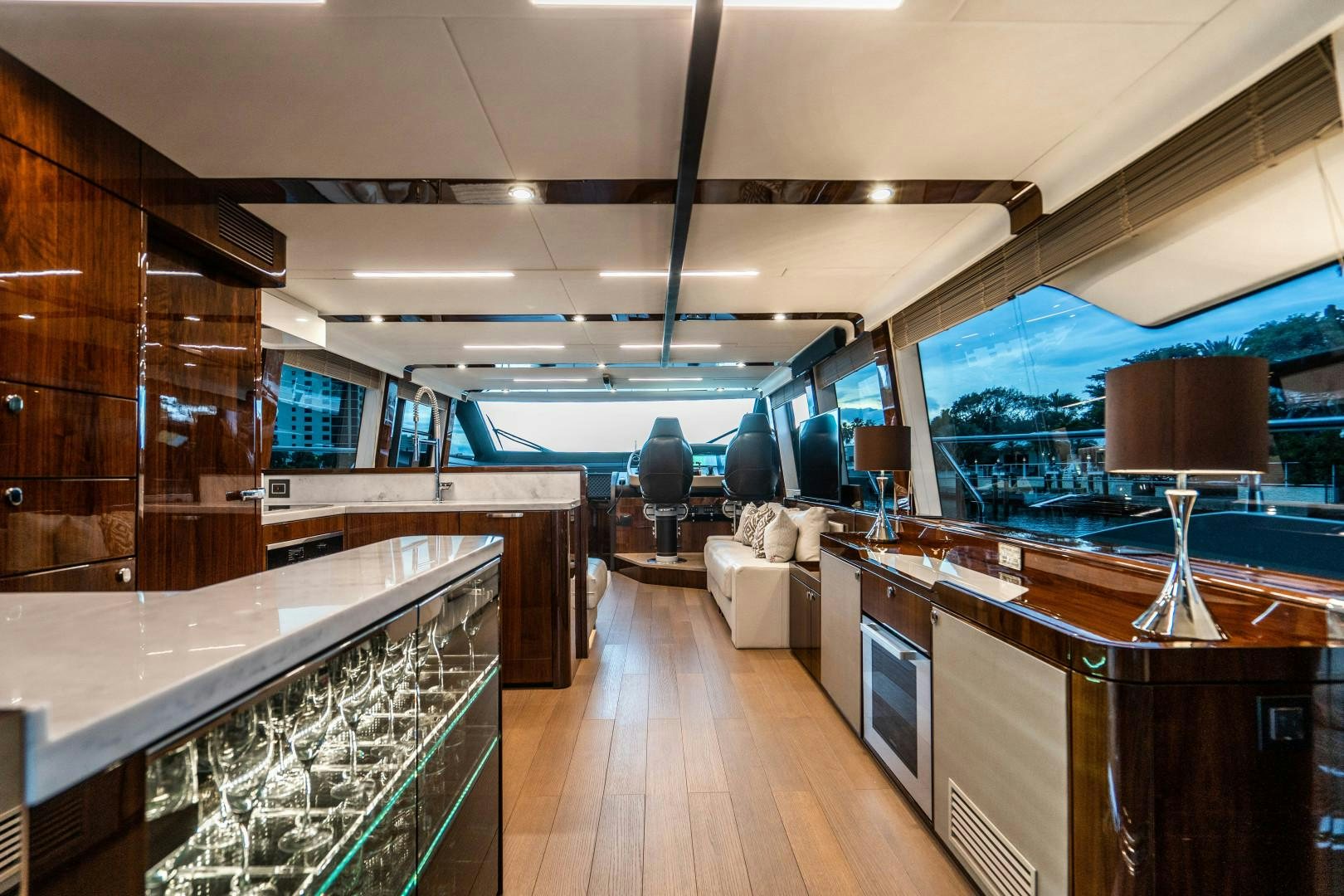 a room with a wood floor and a large window with a view of the ocean aboard BLIND DATE Yacht for Sale