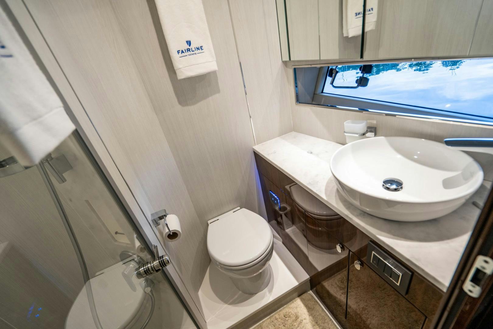 a bathroom with a sink toilet and a mirror aboard BLIND DATE Yacht for Sale