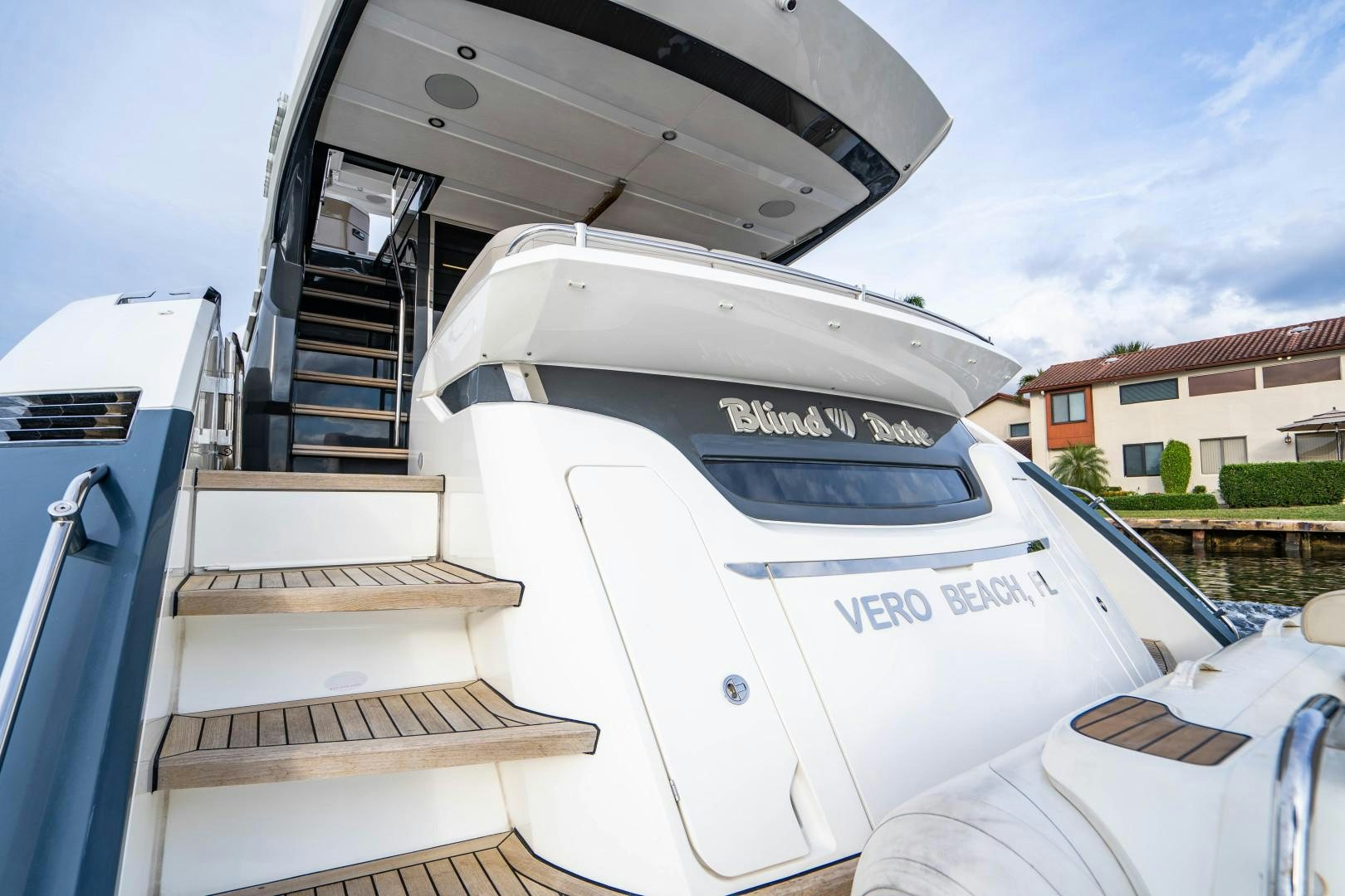 a white boat with a staircase aboard BLIND DATE Yacht for Sale