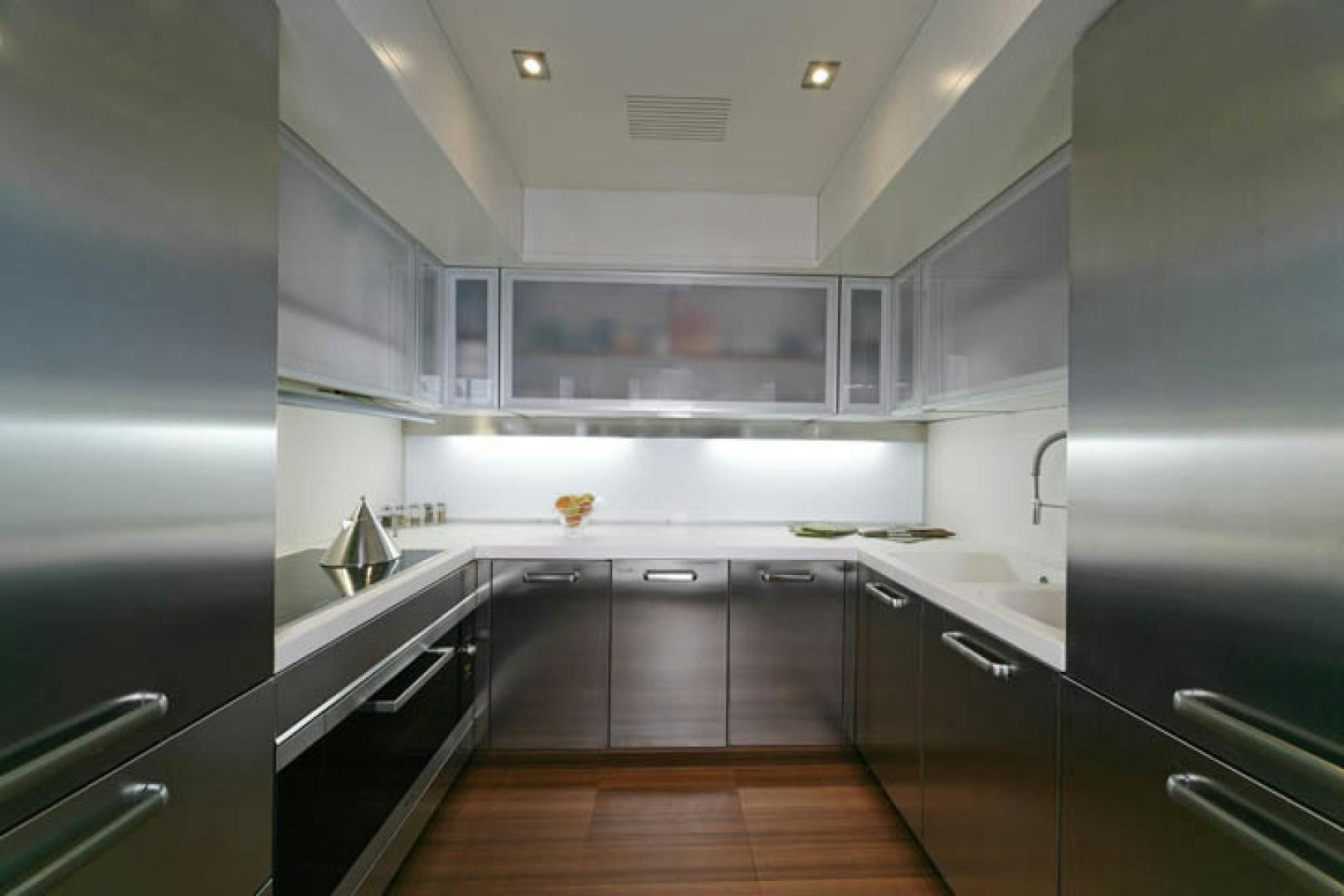 a kitchen with black appliances aboard BLUWATER Yacht for Sale