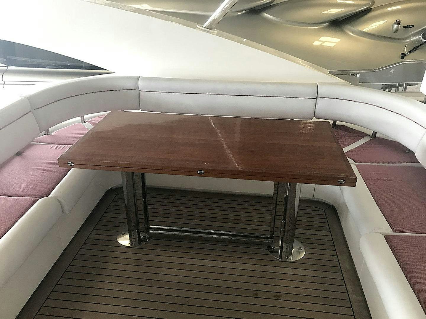 a wooden table on a boat aboard BLUWATER Yacht for Sale
