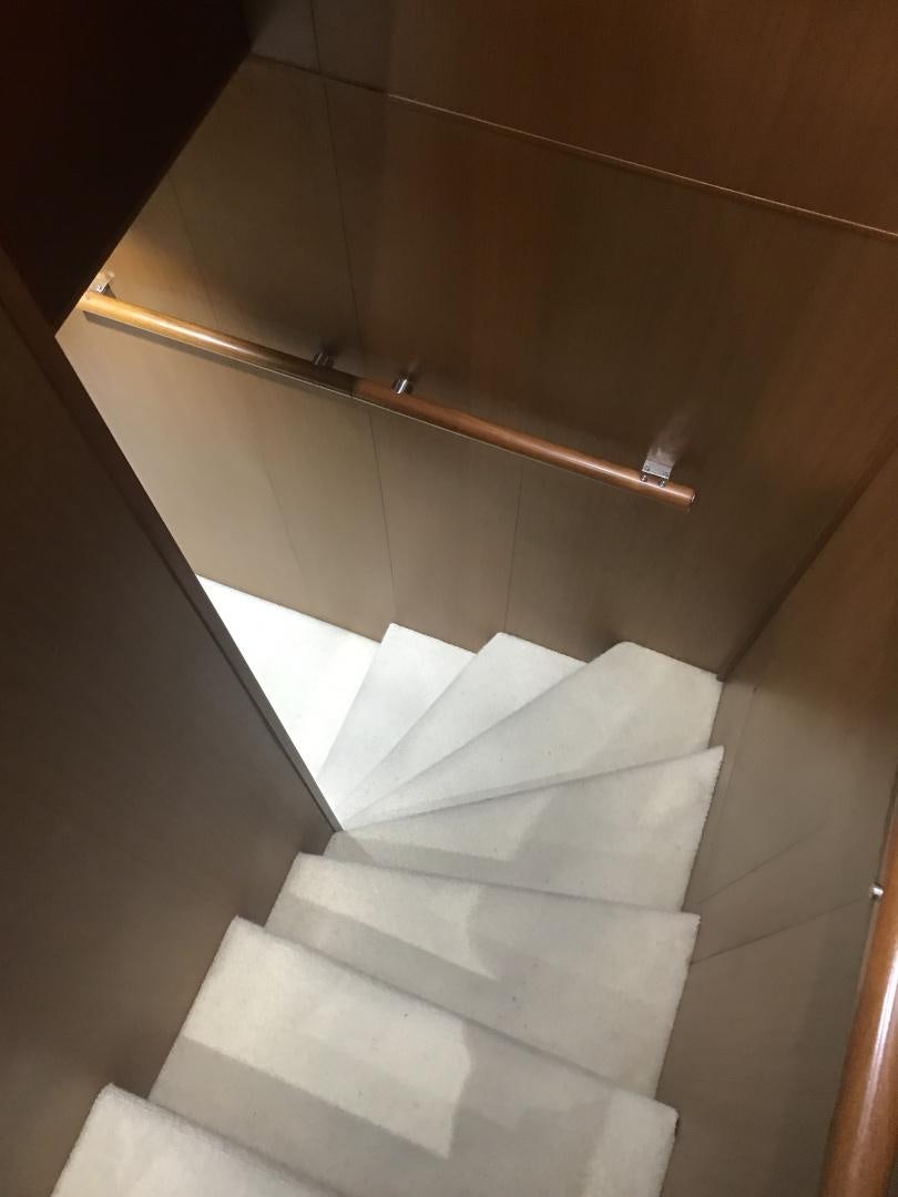 a white staircase with a metal railing aboard BLUWATER Yacht for Sale