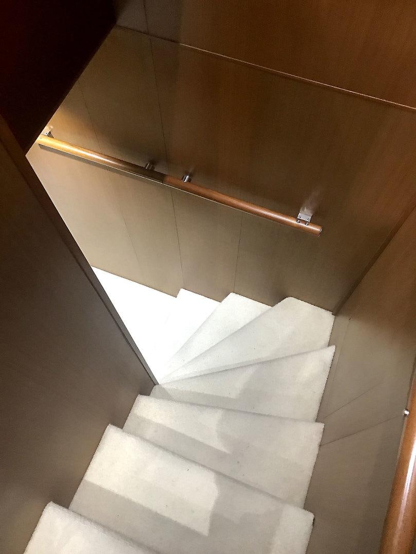 a white staircase with a metal railing aboard BLUWATER Yacht for Sale