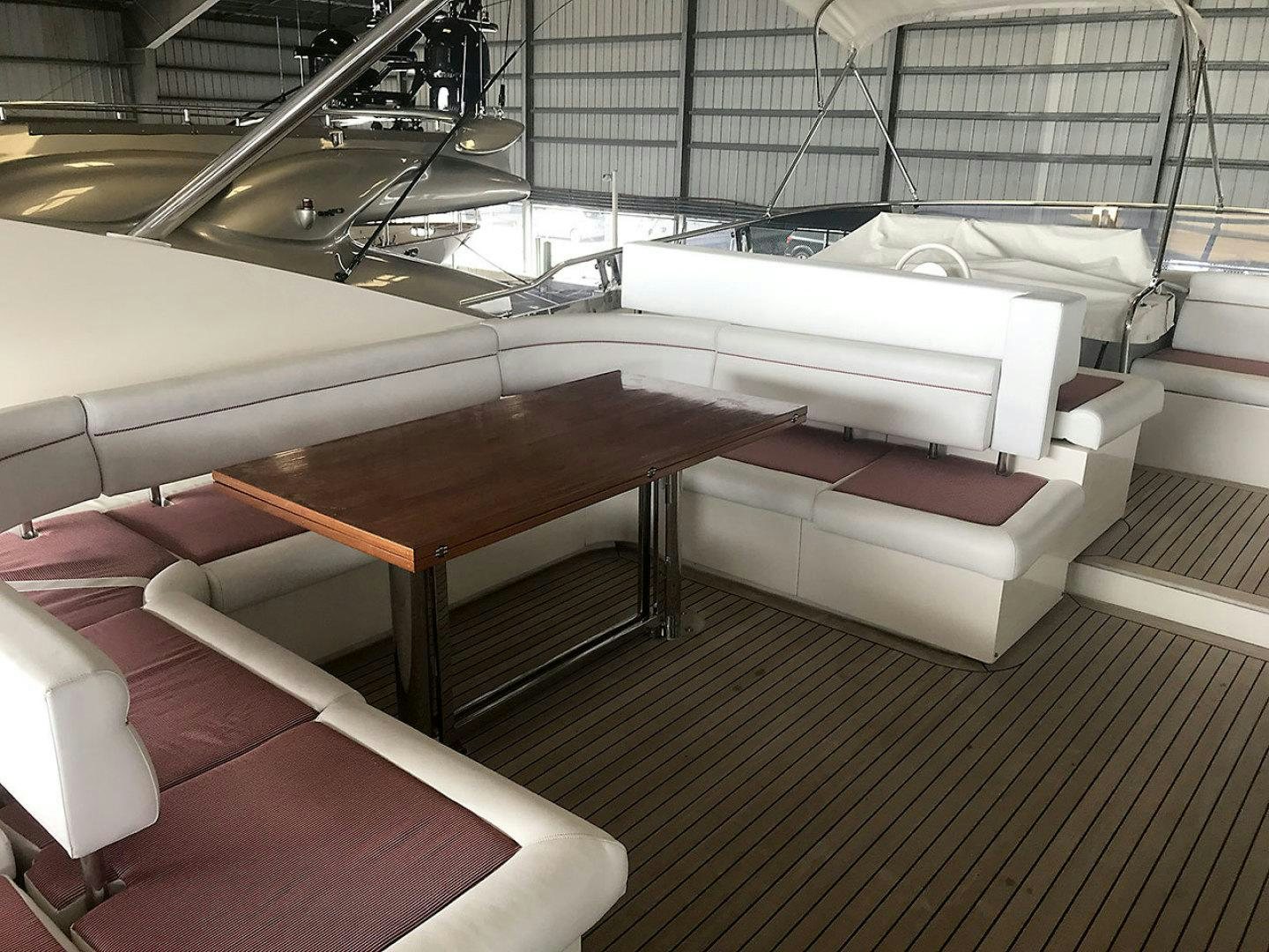a room with couches and a table aboard BLUWATER Yacht for Sale