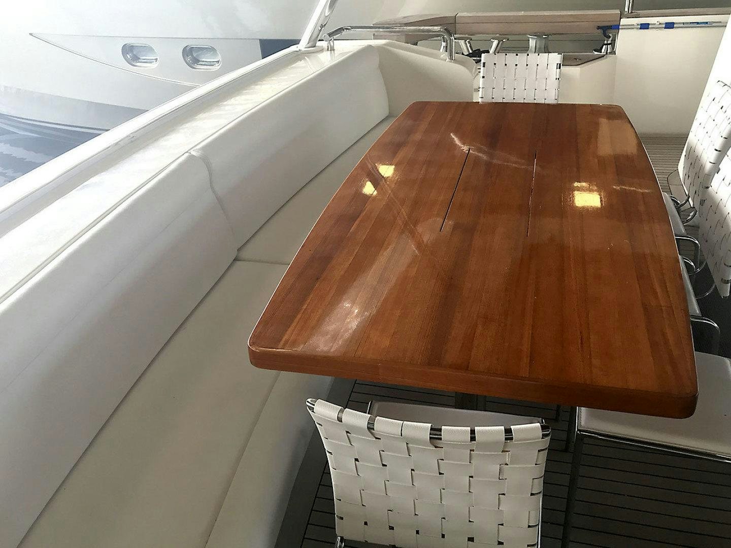 a wooden table on a boat aboard BLUWATER Yacht for Sale