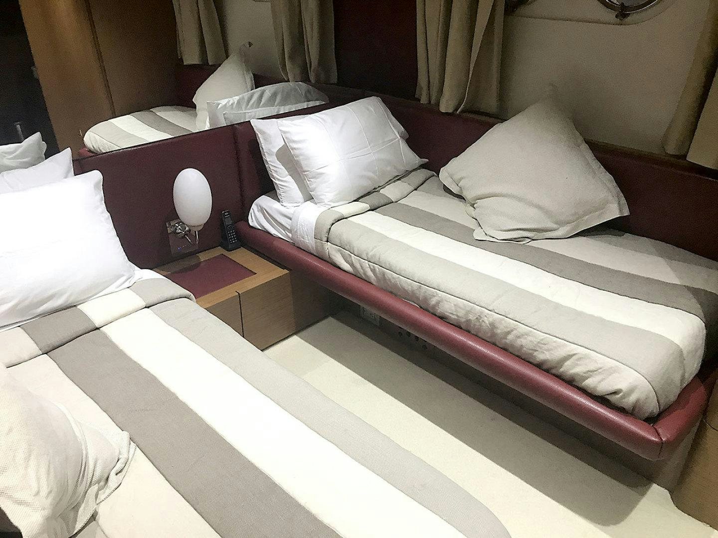 a bed with white pillows aboard BLUWATER Yacht for Sale