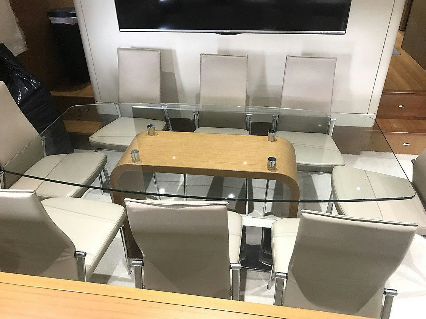 a room with a table and chairs aboard BLUWATER Yacht for Sale