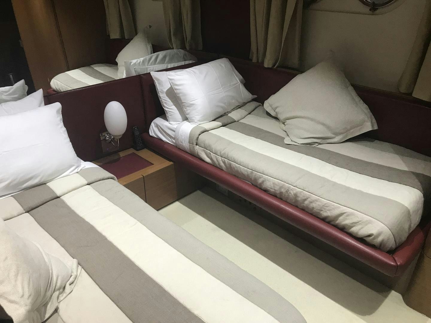 a bed with white pillows aboard BLUWATER Yacht for Sale