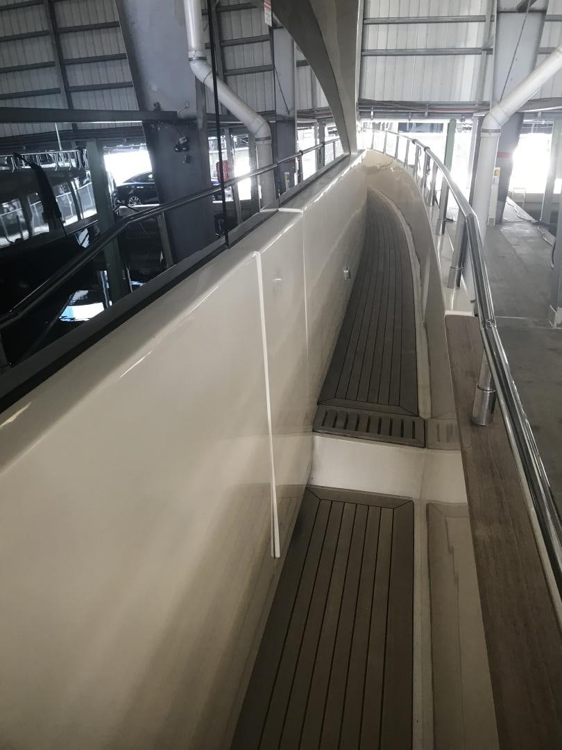 a long hallway with a few cars aboard BLUWATER Yacht for Sale