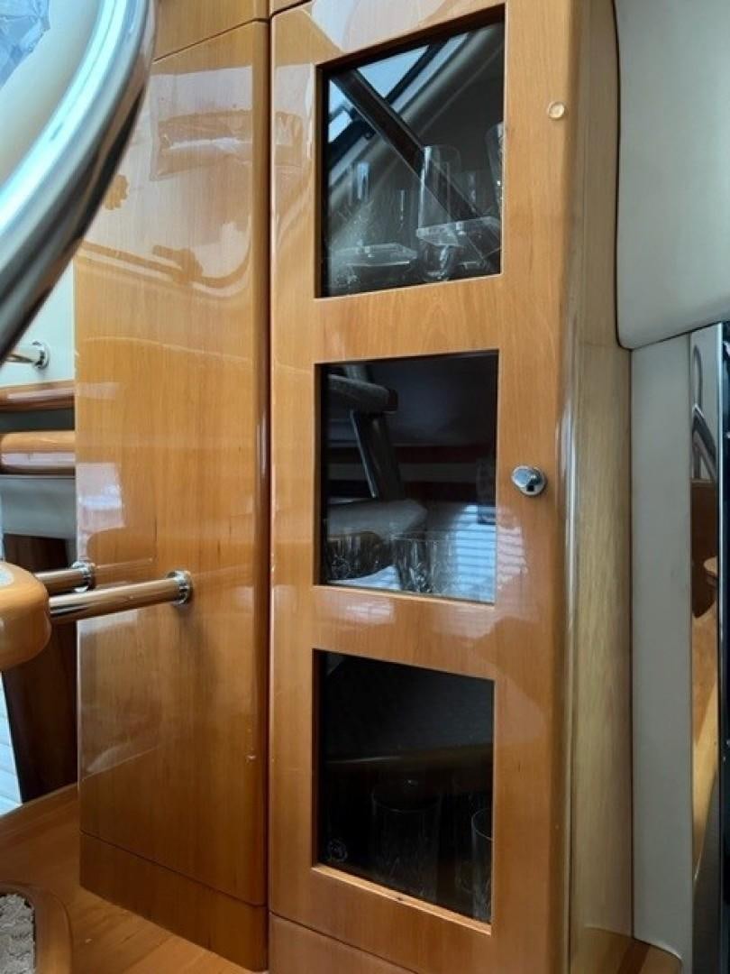 a wooden cabinet with a window aboard JOIE DU ROI Yacht for Sale