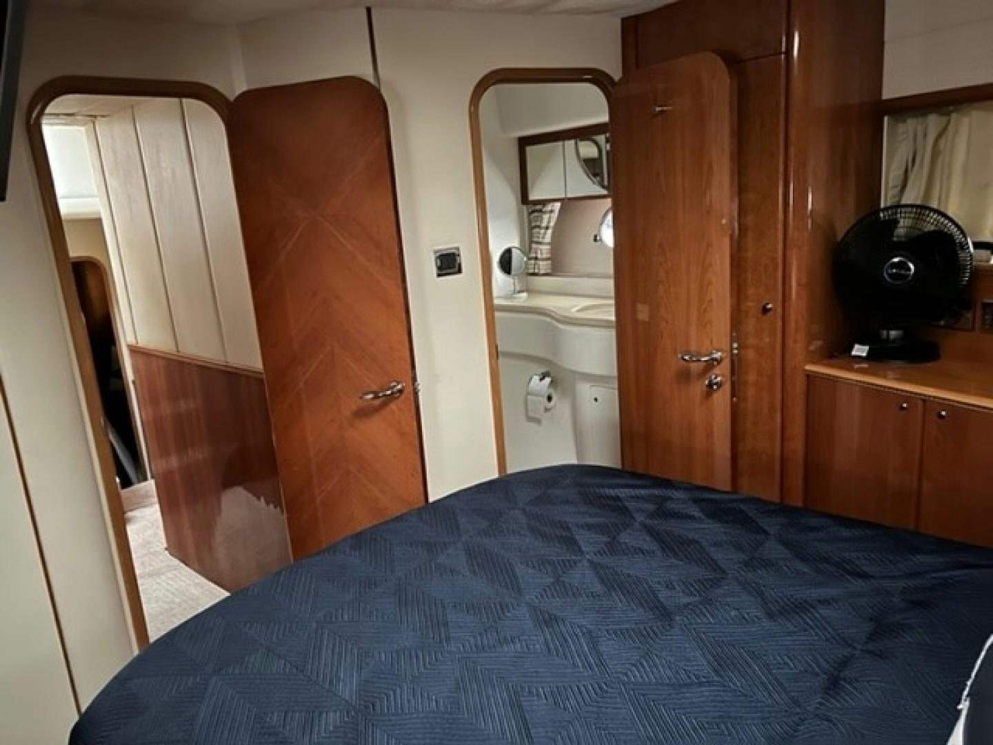 a bedroom with a bed and a closet aboard JOIE DU ROI Yacht for Sale