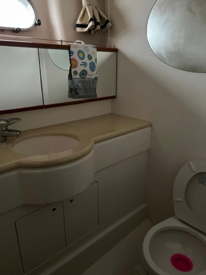 a bathroom with a toilet and sink aboard JOIE DU ROI Yacht for Sale