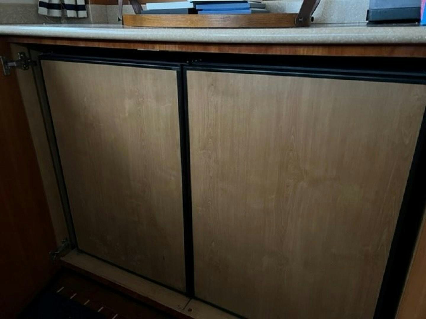 a wooden cabinet with drawers aboard JOIE DU ROI Yacht for Sale