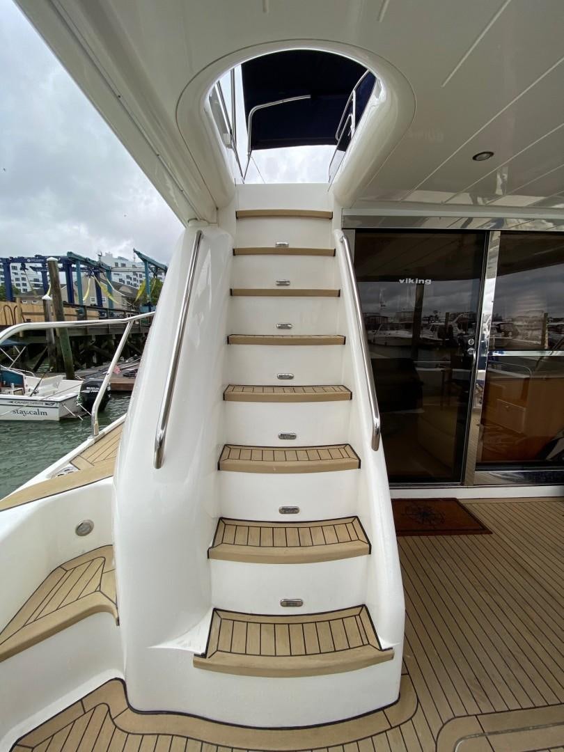 a large white boat in a room aboard JOIE DU ROI Yacht for Sale