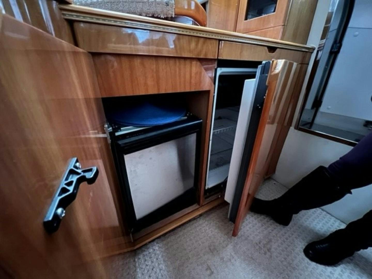 a kitchen with a wood cabinet aboard JOIE DU ROI Yacht for Sale