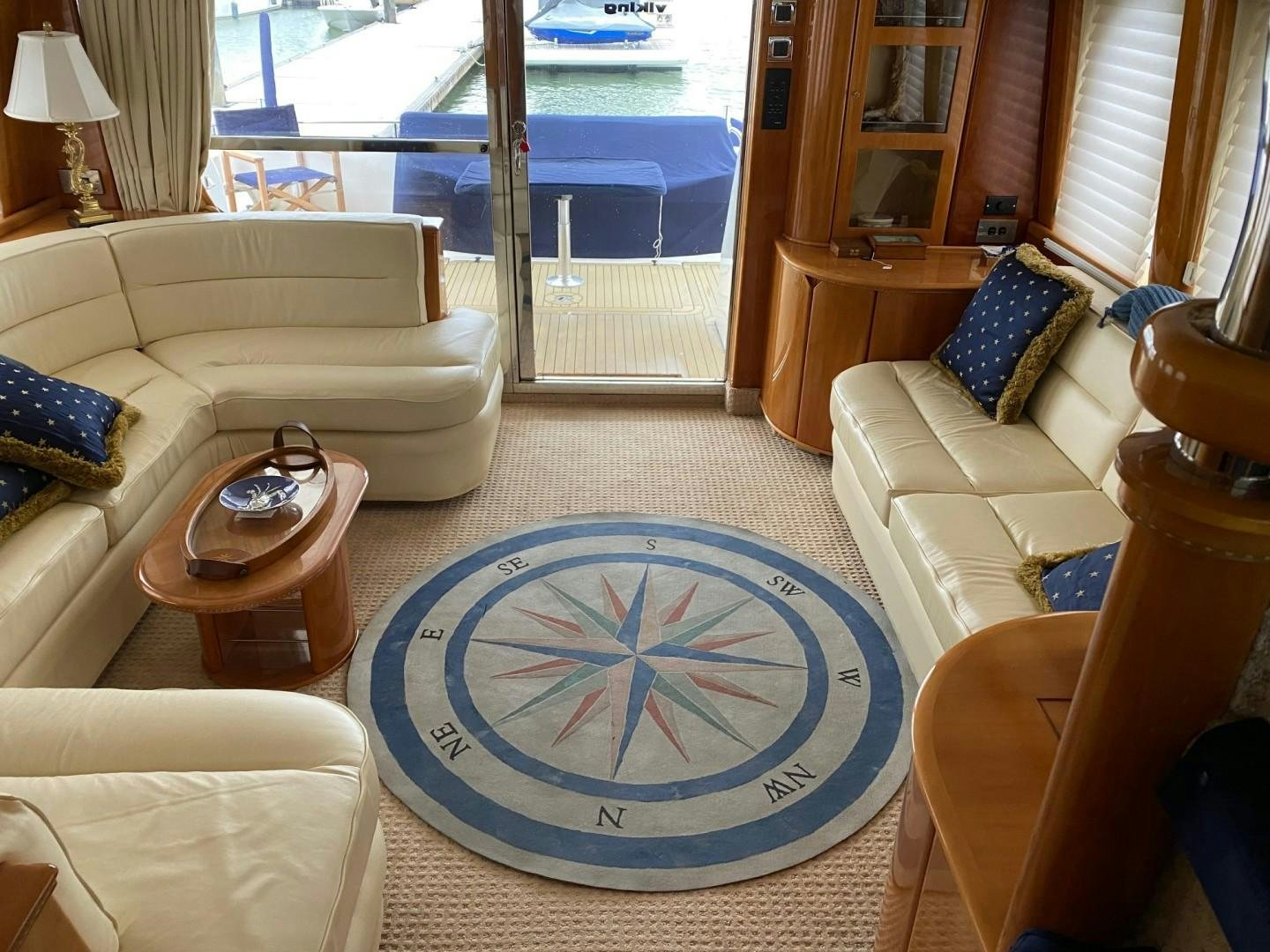 a living room with a blue rug aboard JOIE DU ROI Yacht for Sale