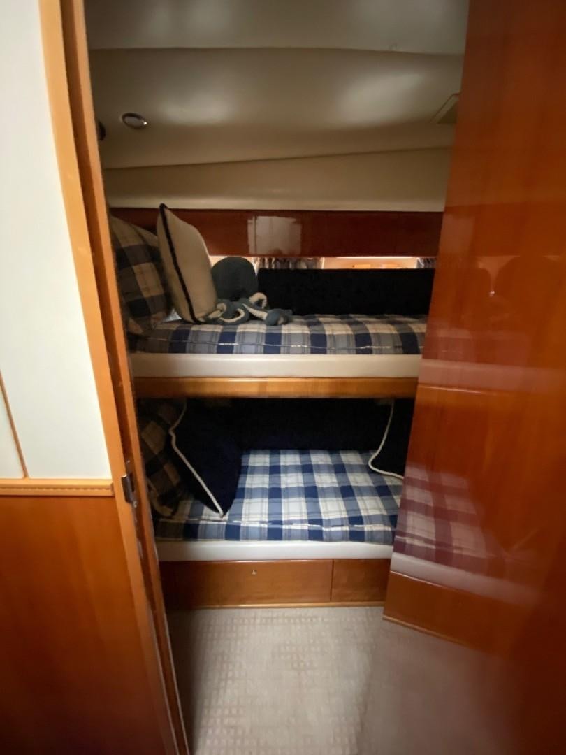 a room with a bed and a table aboard JOIE DU ROI Yacht for Sale