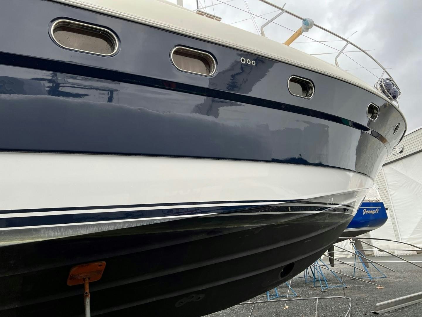 a white yacht with a blue stripe aboard JOIE DU ROI Yacht for Sale