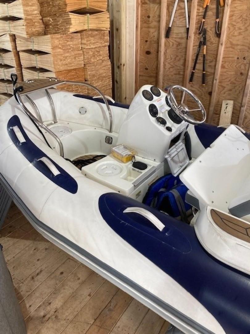 a group of white and blue and silver boats on a wooden deck aboard JOIE DU ROI Yacht for Sale