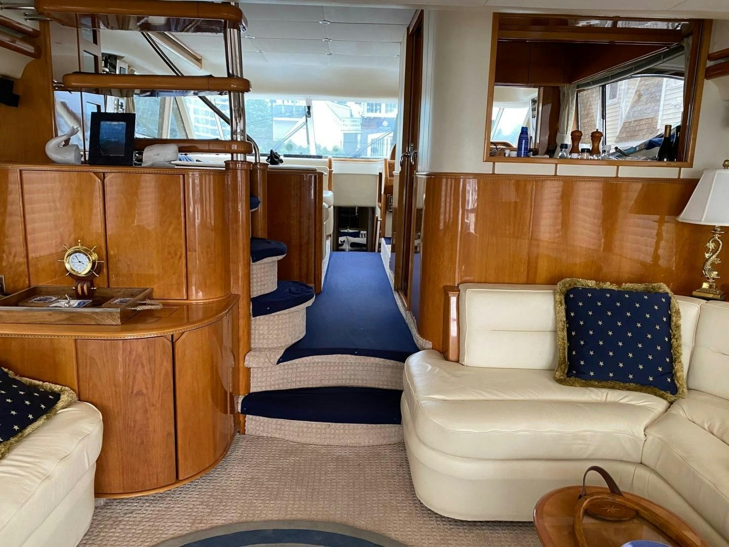 a living room with a wood cabinet aboard JOIE DU ROI Yacht for Sale
