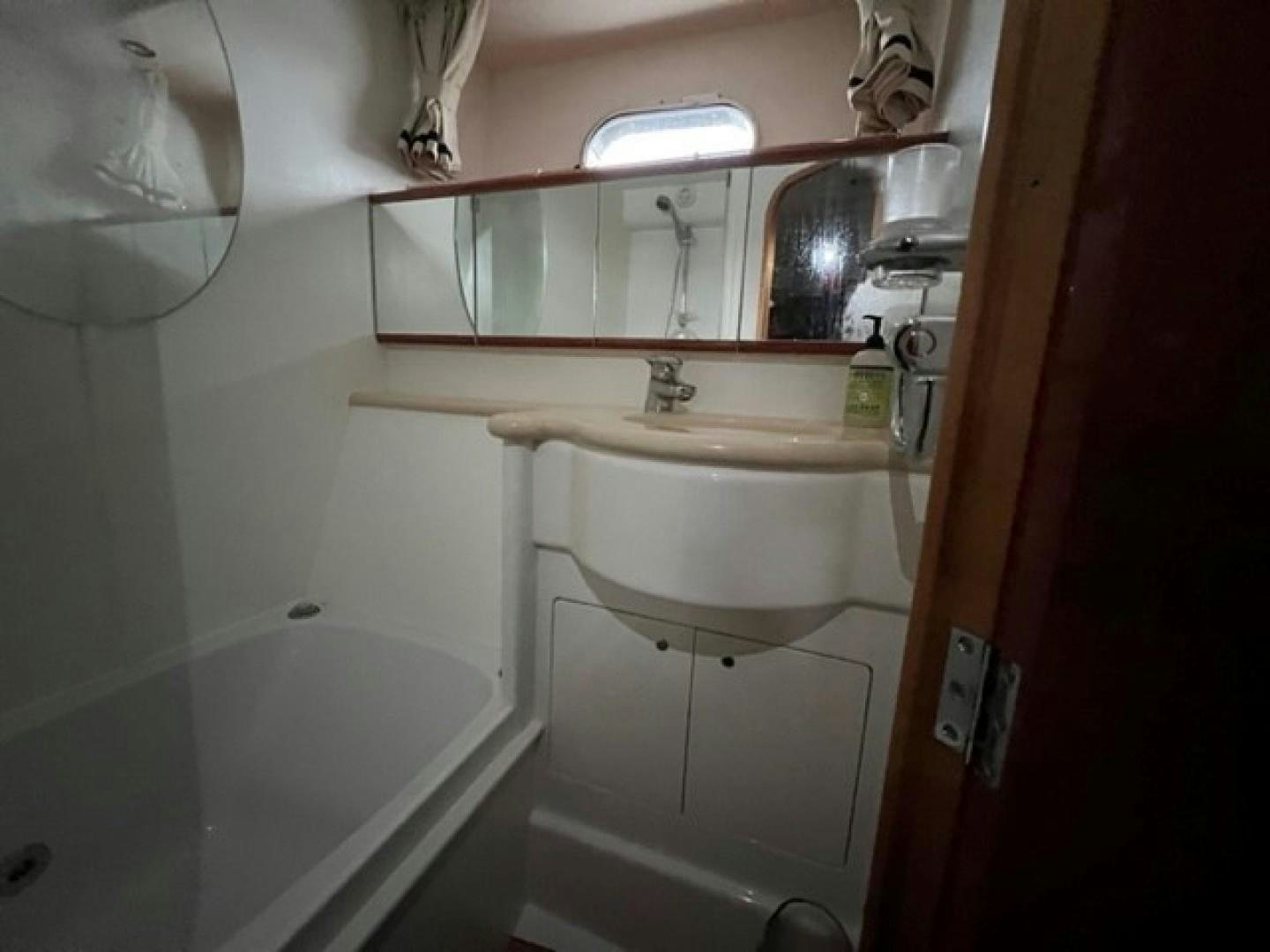 a bathroom with a sink and a mirror aboard JOIE DU ROI Yacht for Sale