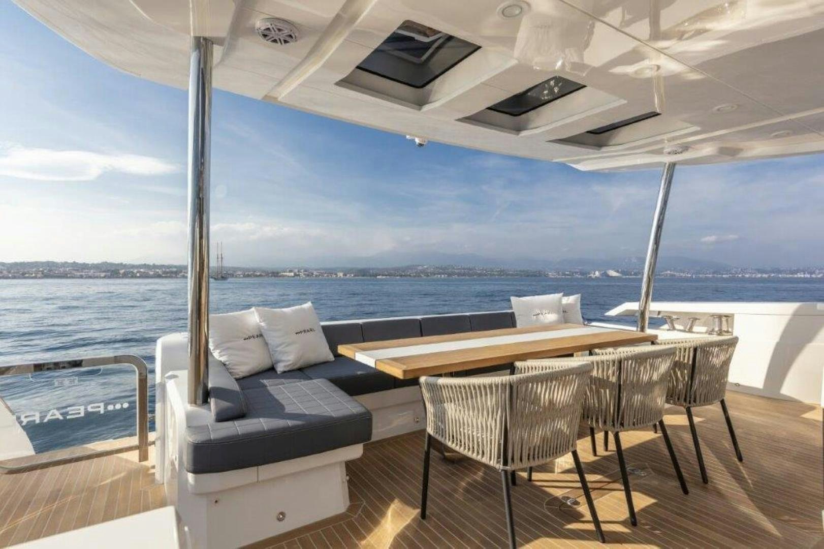 a table and chairs on a deck aboard NONE Yacht for Sale