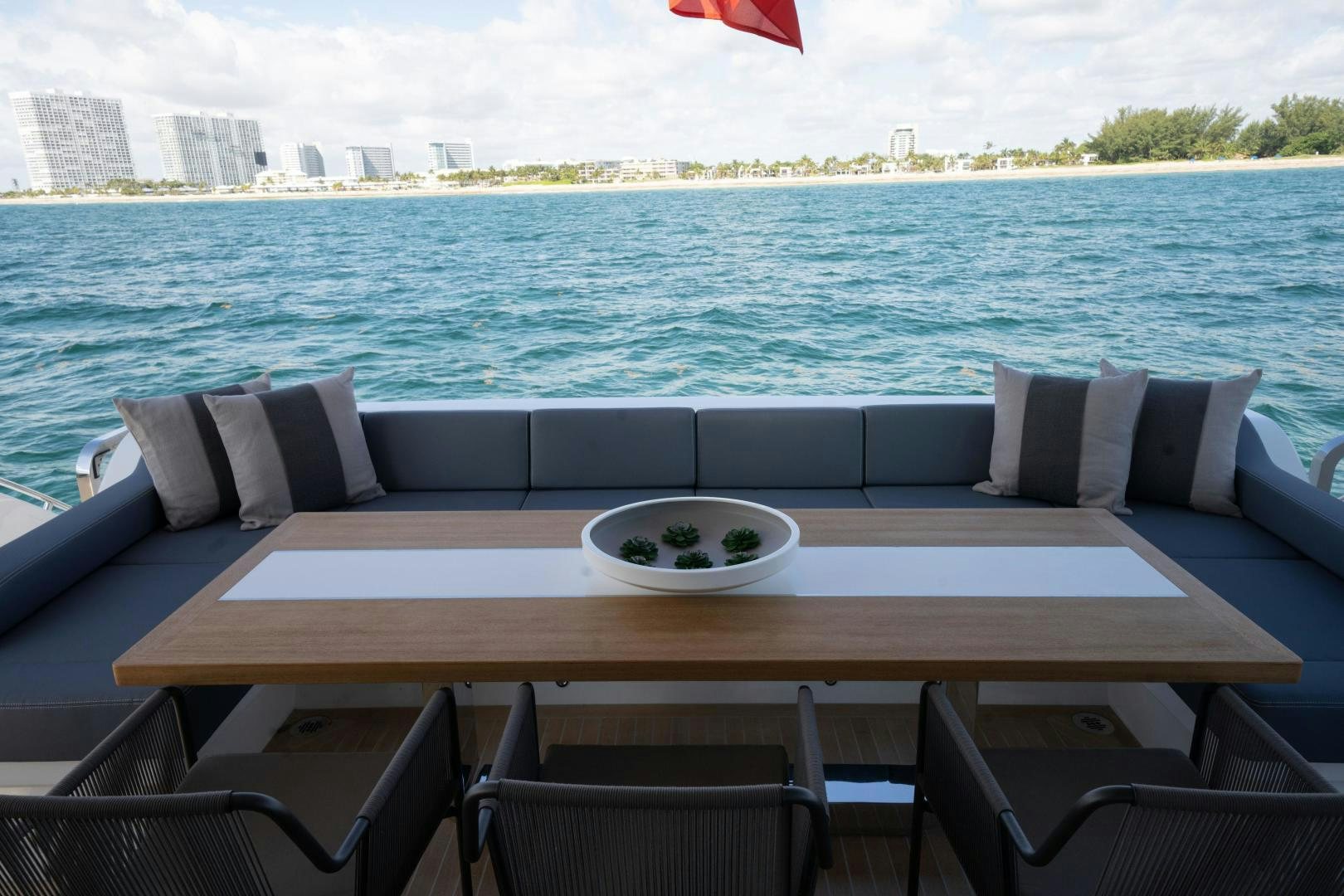 a table with chairs on it by the water aboard NONE Yacht for Sale
