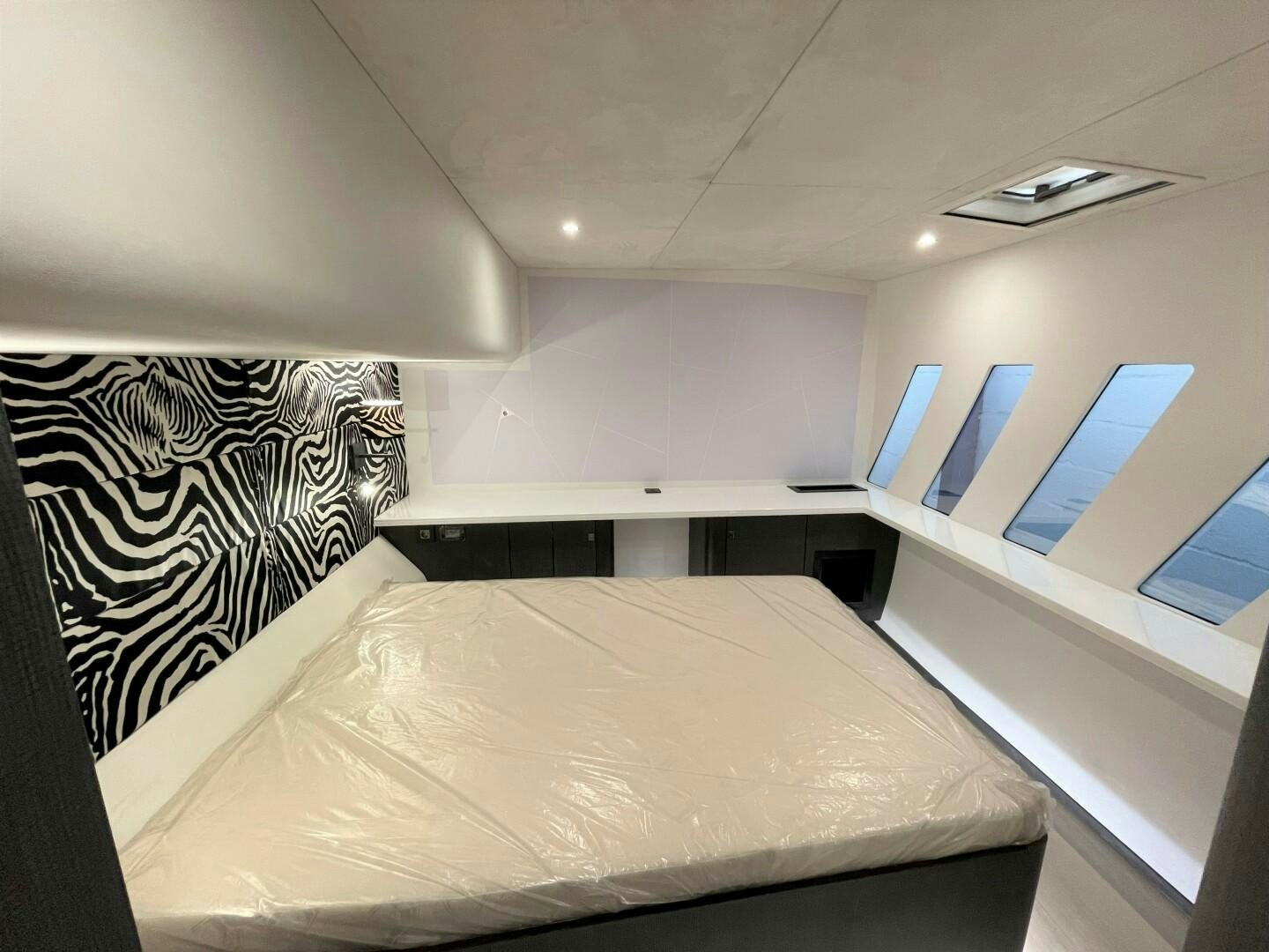a room with a bed and a window aboard SKYE Yacht for Sale