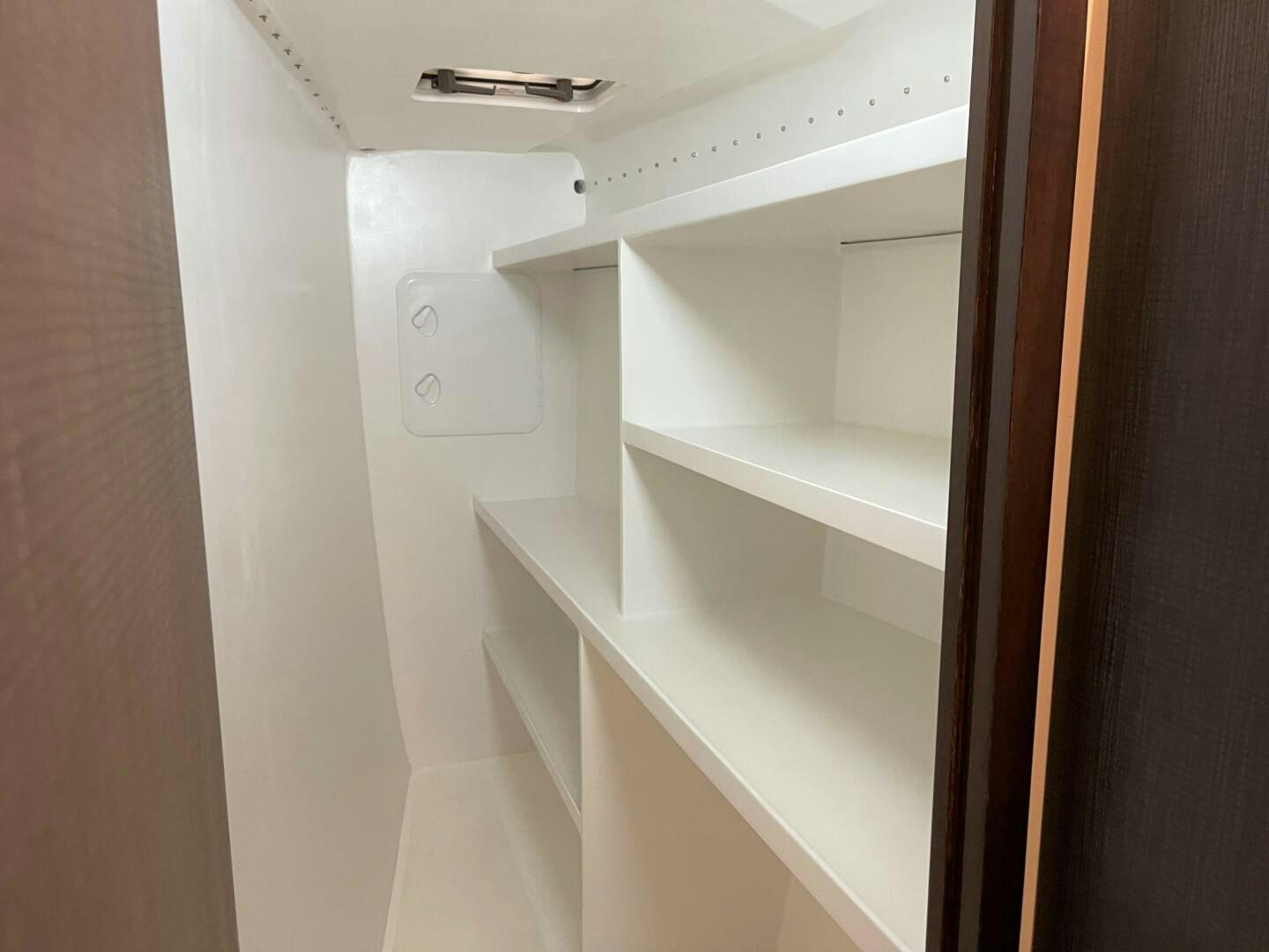 a white cabinet with a vent aboard SKYE Yacht for Sale