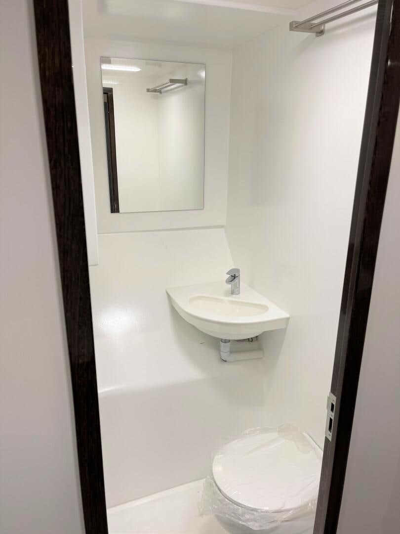 a bathroom with a sink and a mirror aboard SKYE Yacht for Sale