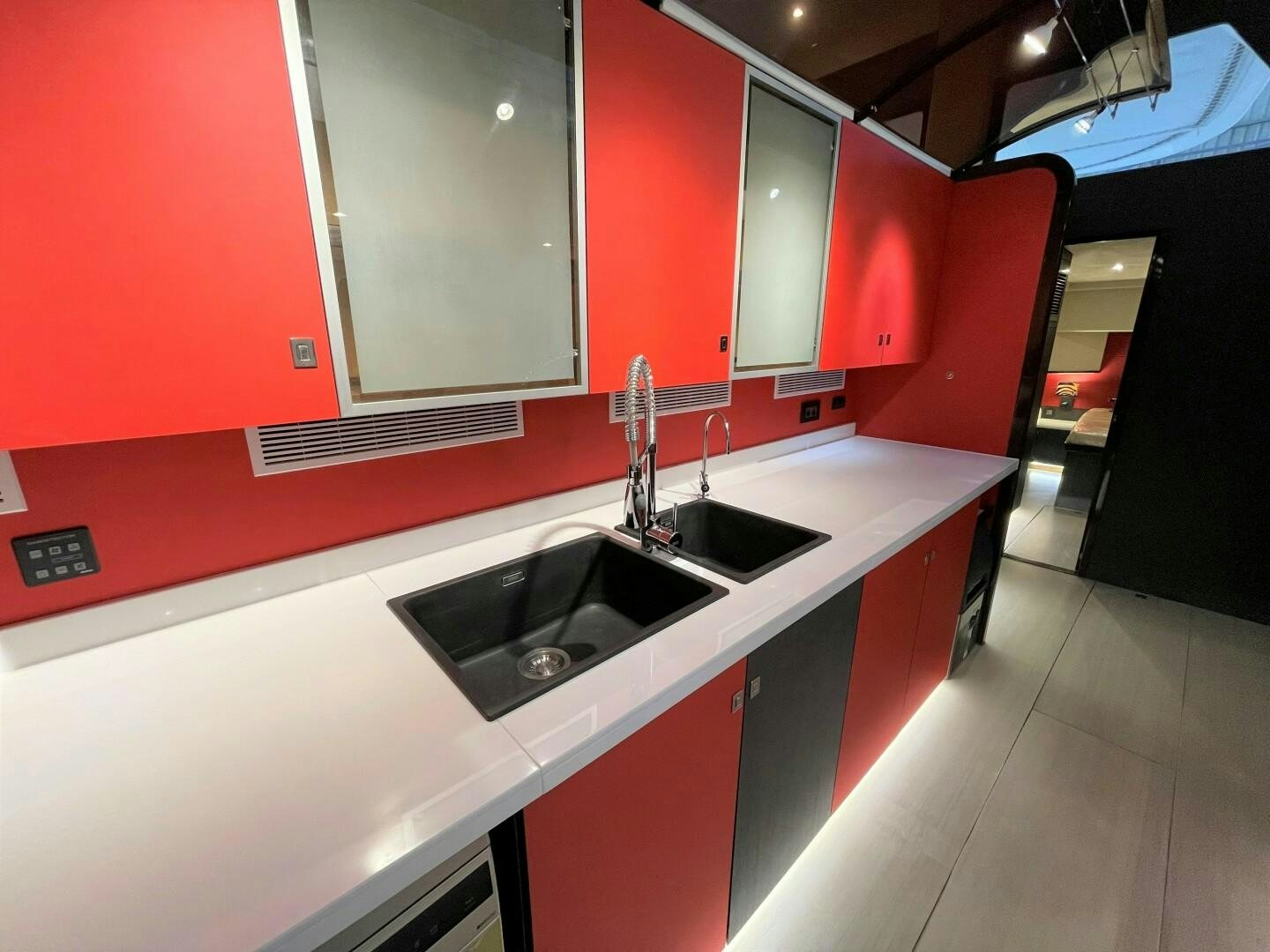 a kitchen with red cabinets aboard SKYE Yacht for Sale