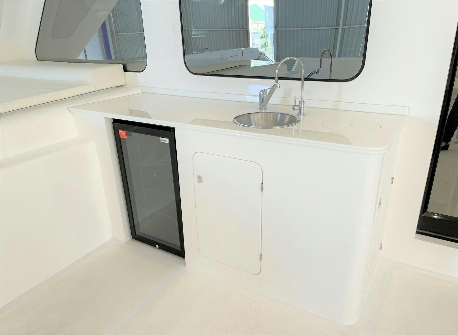 a sink and microwave in a kitchen aboard SKYE Yacht for Sale