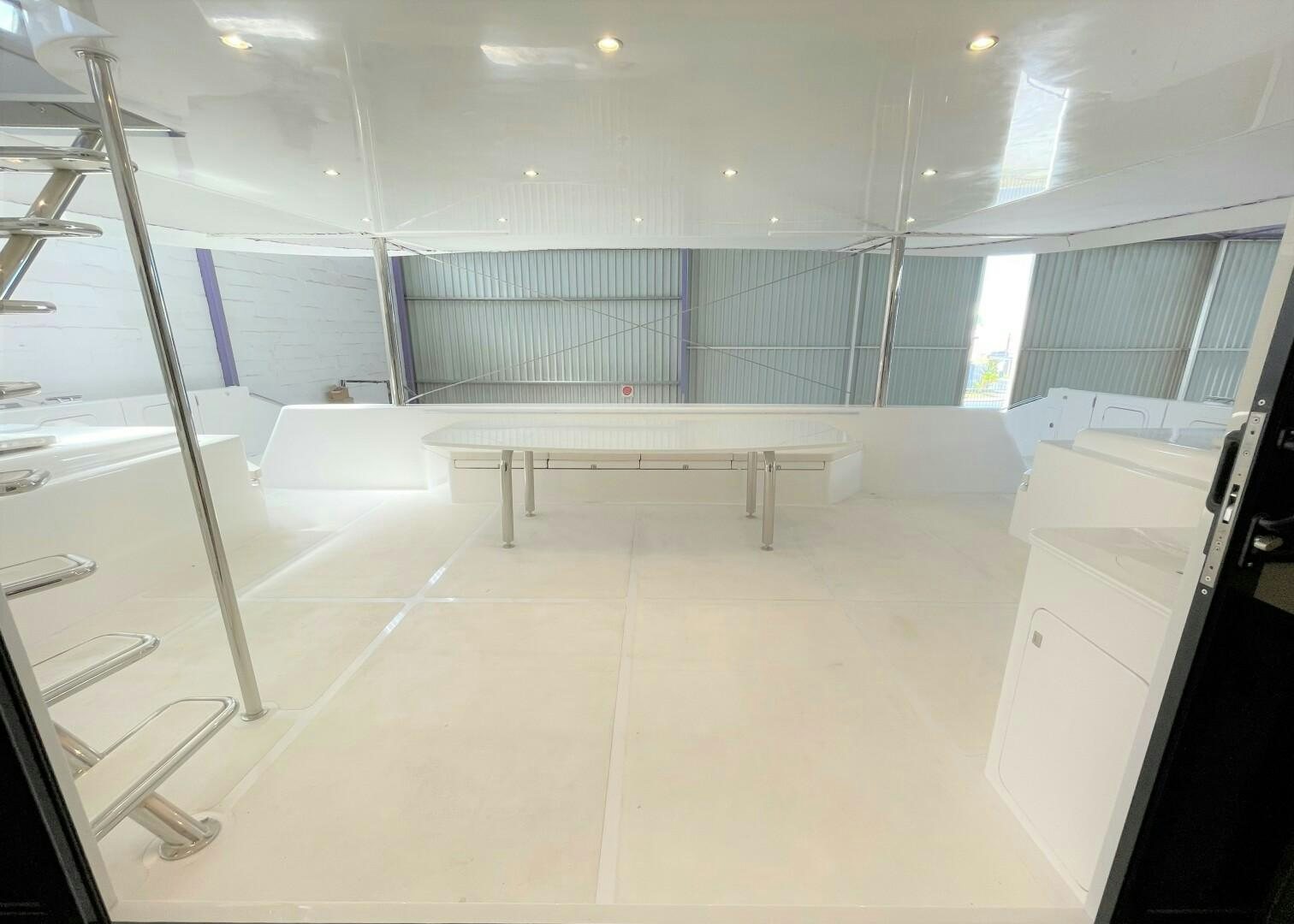 a room with white cabinets and a table and chairs aboard SKYE Yacht for Sale