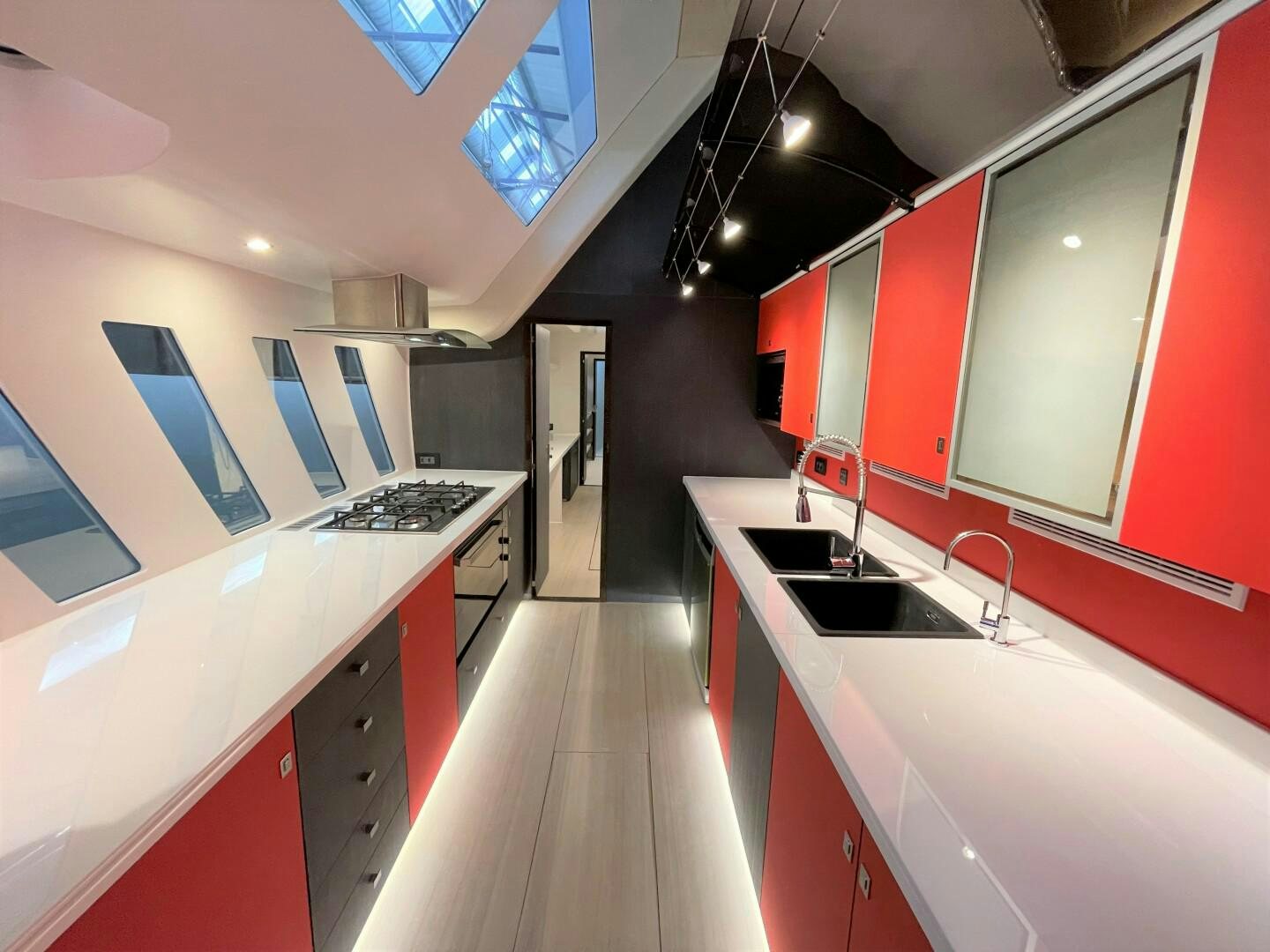 a kitchen with red cabinets aboard SKYE Yacht for Sale