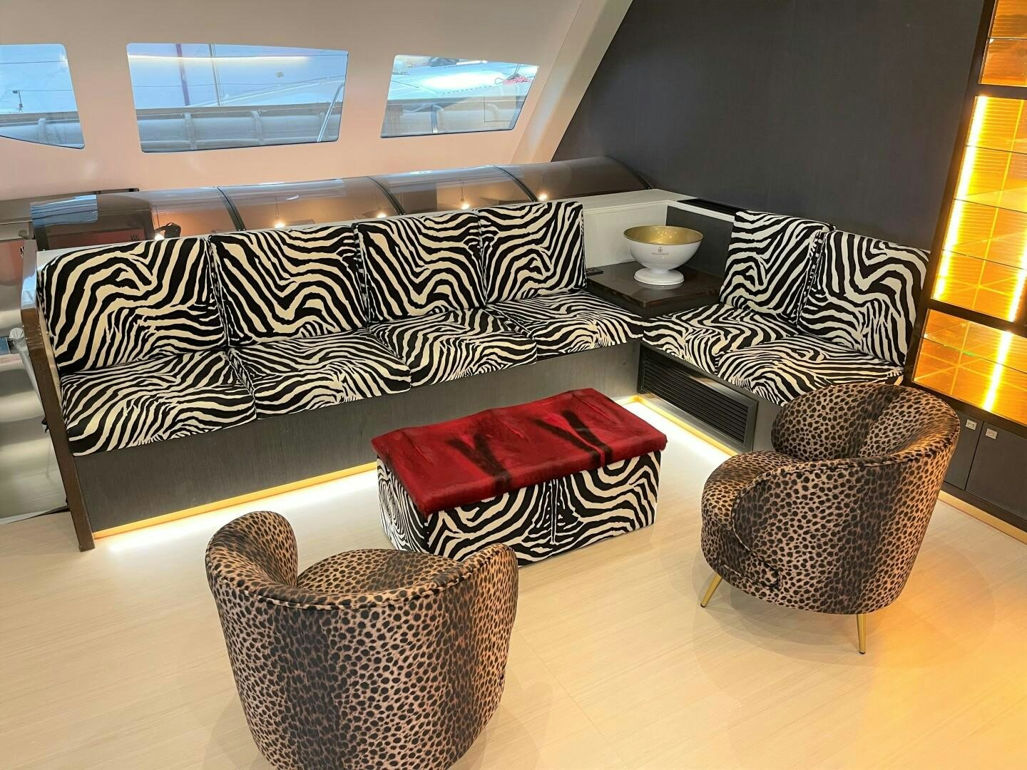 a couch with a rug and cups on it aboard SKYE Yacht for Sale