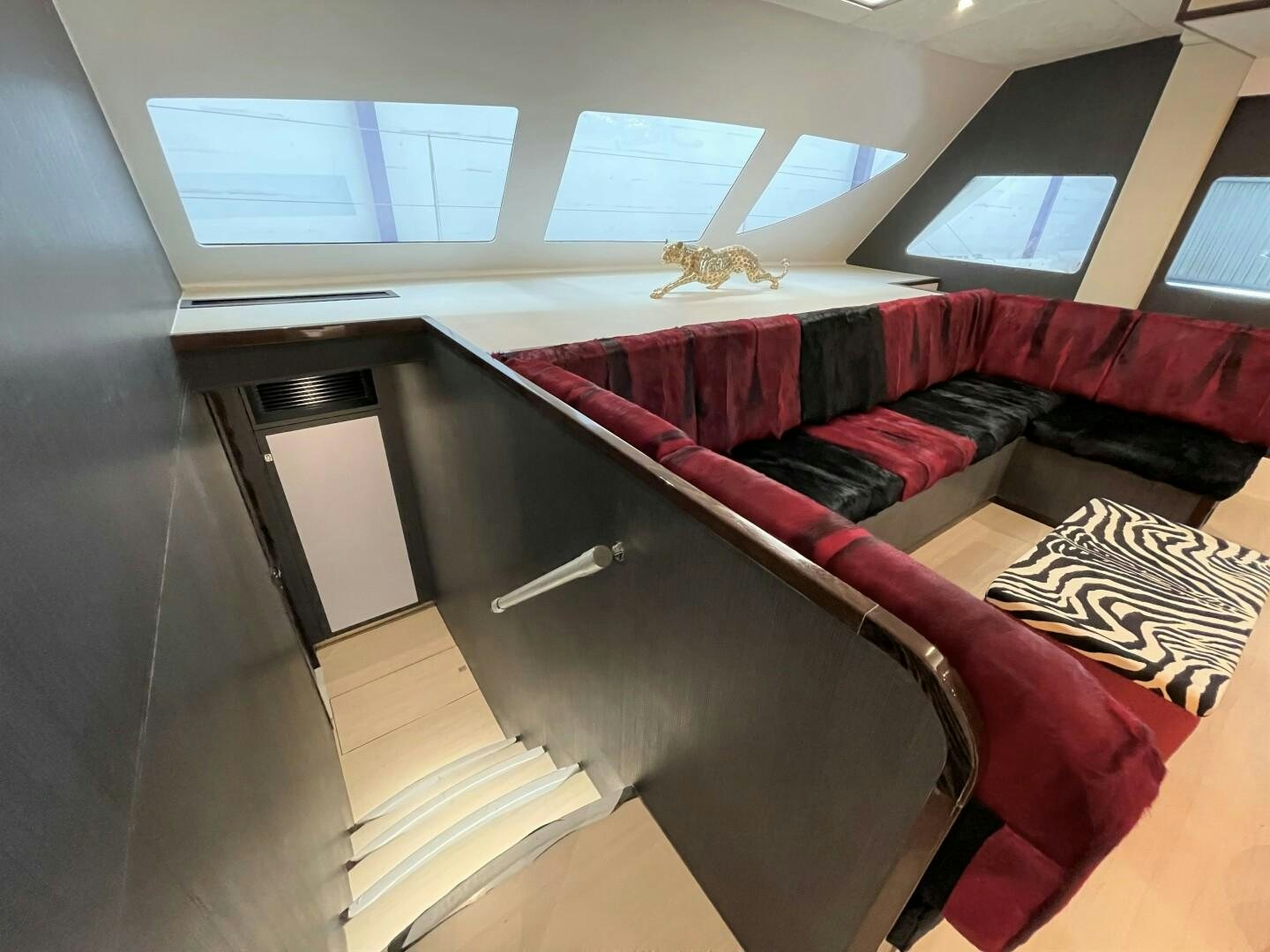 a room with a couch and a window aboard SKYE Yacht for Sale