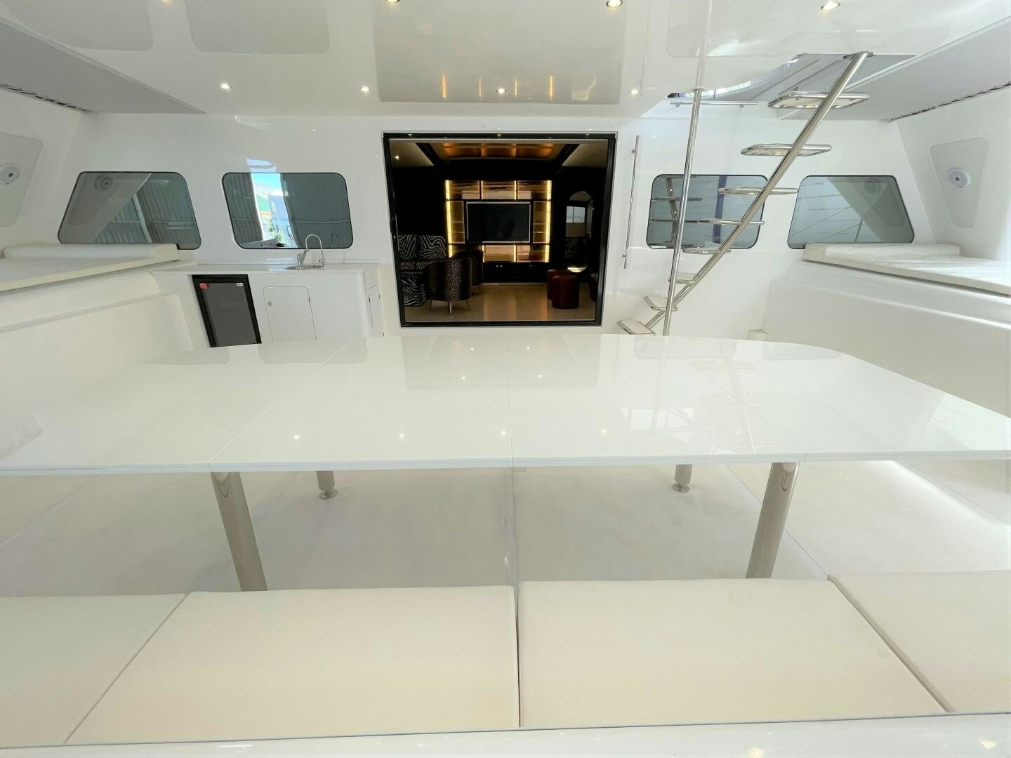 a room with a large mirror and a table with chairs aboard SKYE Yacht for Sale